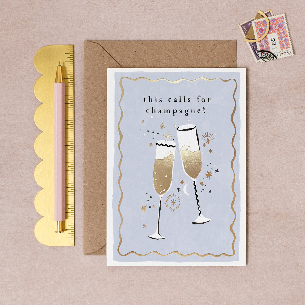 Golden champagne glasses congratulations card