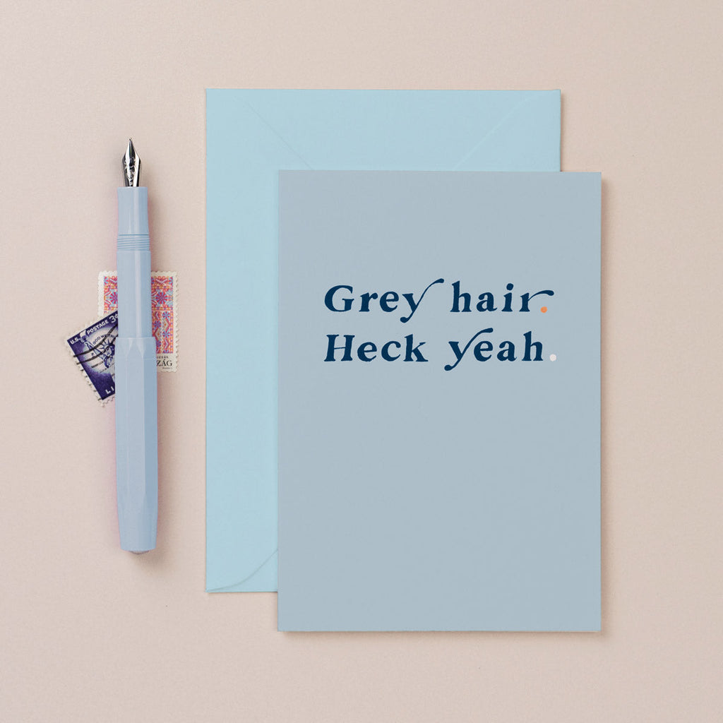 A funny birthday card with grey hair heck yeah lettering on a birthday card from the funny birthday card collection at Sister Paper Co.
