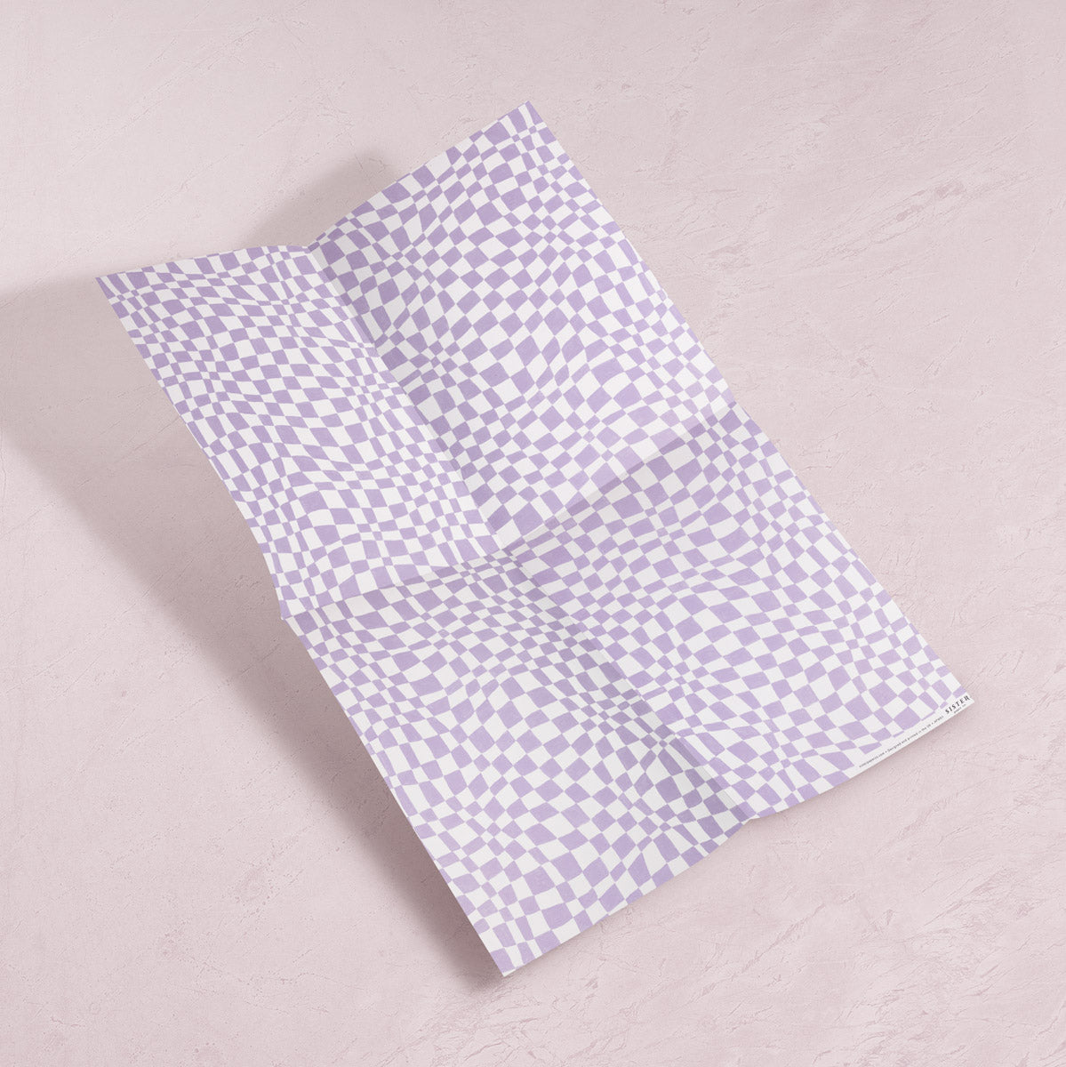 A lilac checkerboard print on wrapping paper from the female birthday wrapping paper collection at Sister Paper Co.