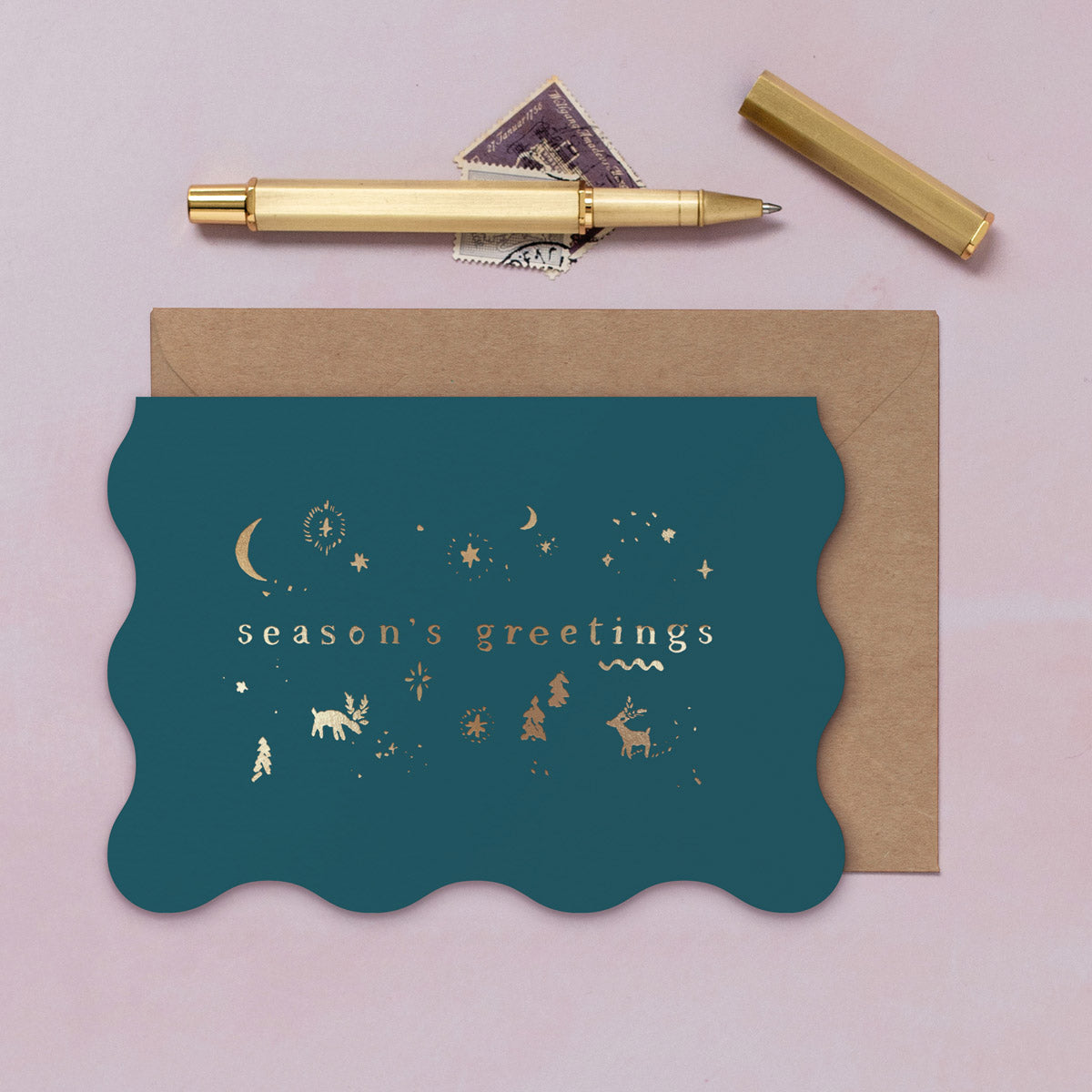 A wavy edge Christmas card with sparkly gold foil icons from the Sister Paper Co. collection of Christmas cards.