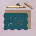 A wavy edge Christmas card with sparkly gold foil icons from the Sister Paper Co. collection of Christmas cards.