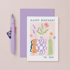 A stylish flower and candle illustration on a birthday card from the female birthday card collection at Sister Paper Co.