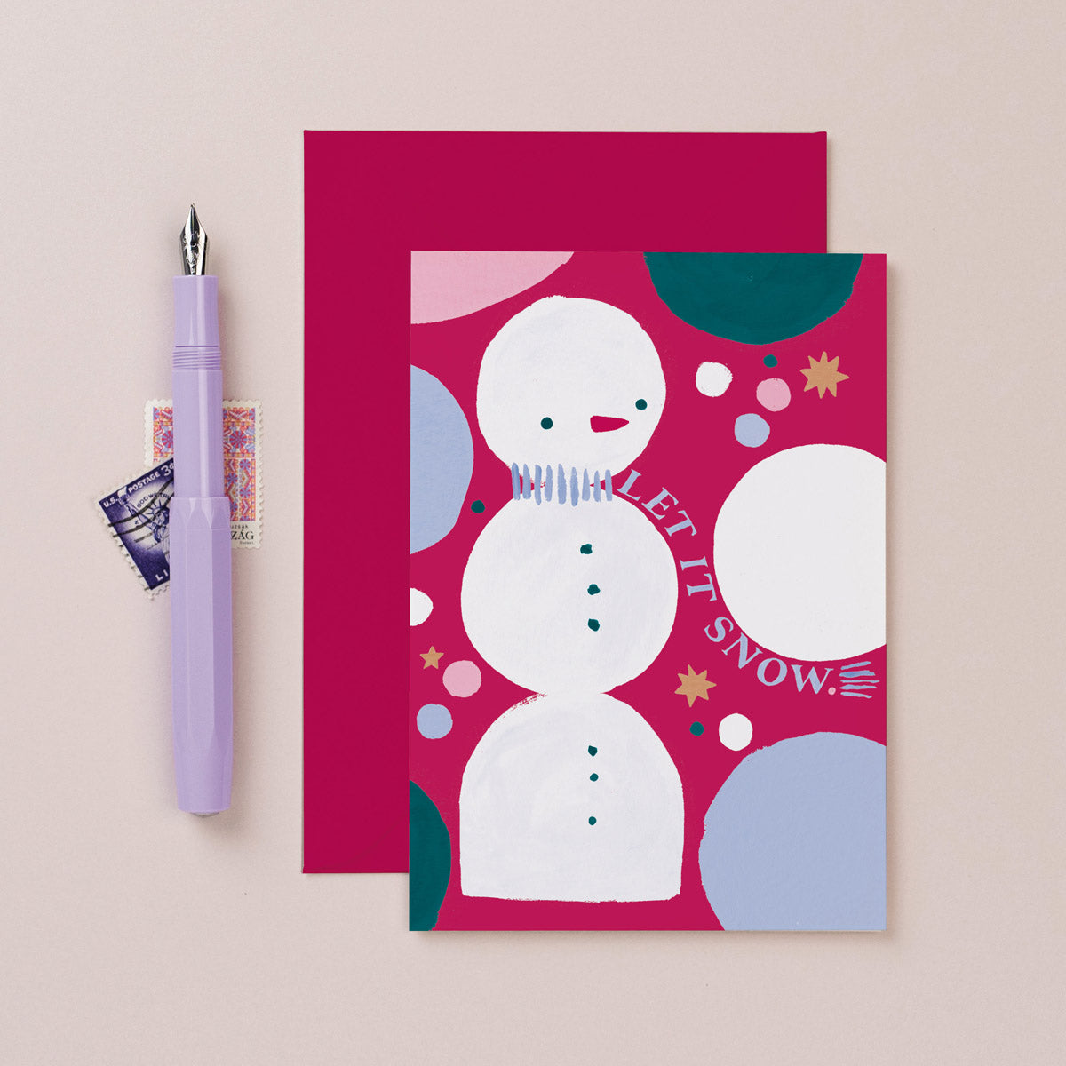 A jolly snowman and rainbow dots on a Christmas card from the colourful, rainbow Christmas card collection at Sister Paper Co.