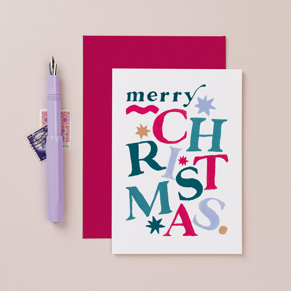 Rainbow lettering on a Christmas card from the colourful, rainbow Christmas card collection at Sister Paper Co.