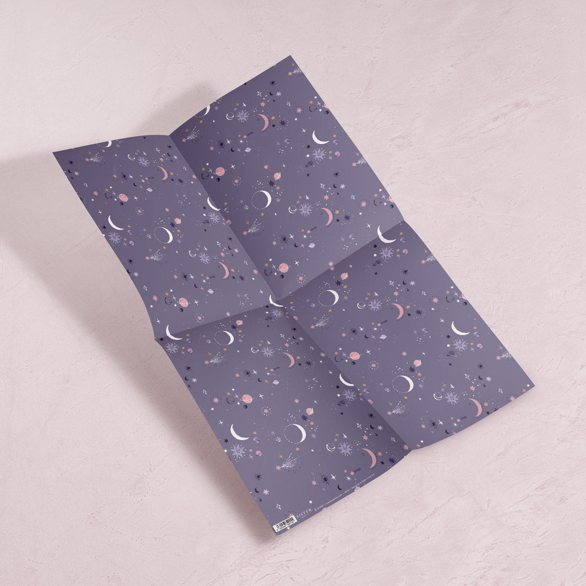 A cosmic, solar system print on wrapping paper from the female birthday wrapping paper collection at Sister Paper Co.