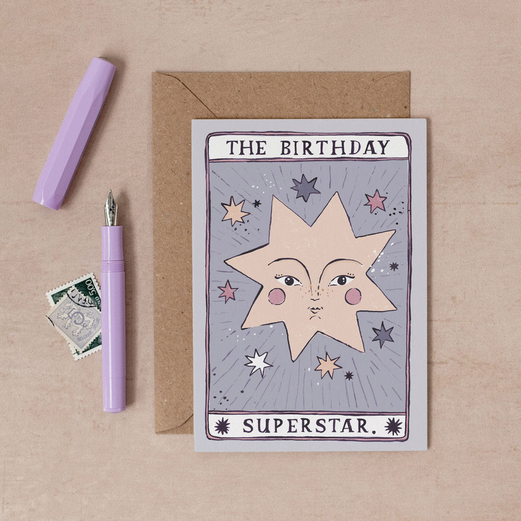 A handmade tarot card style card with illustrated beautiful face and birthday superstar hand lettering on a birthday card from the female birthday card collection at Sister Paper Co.
