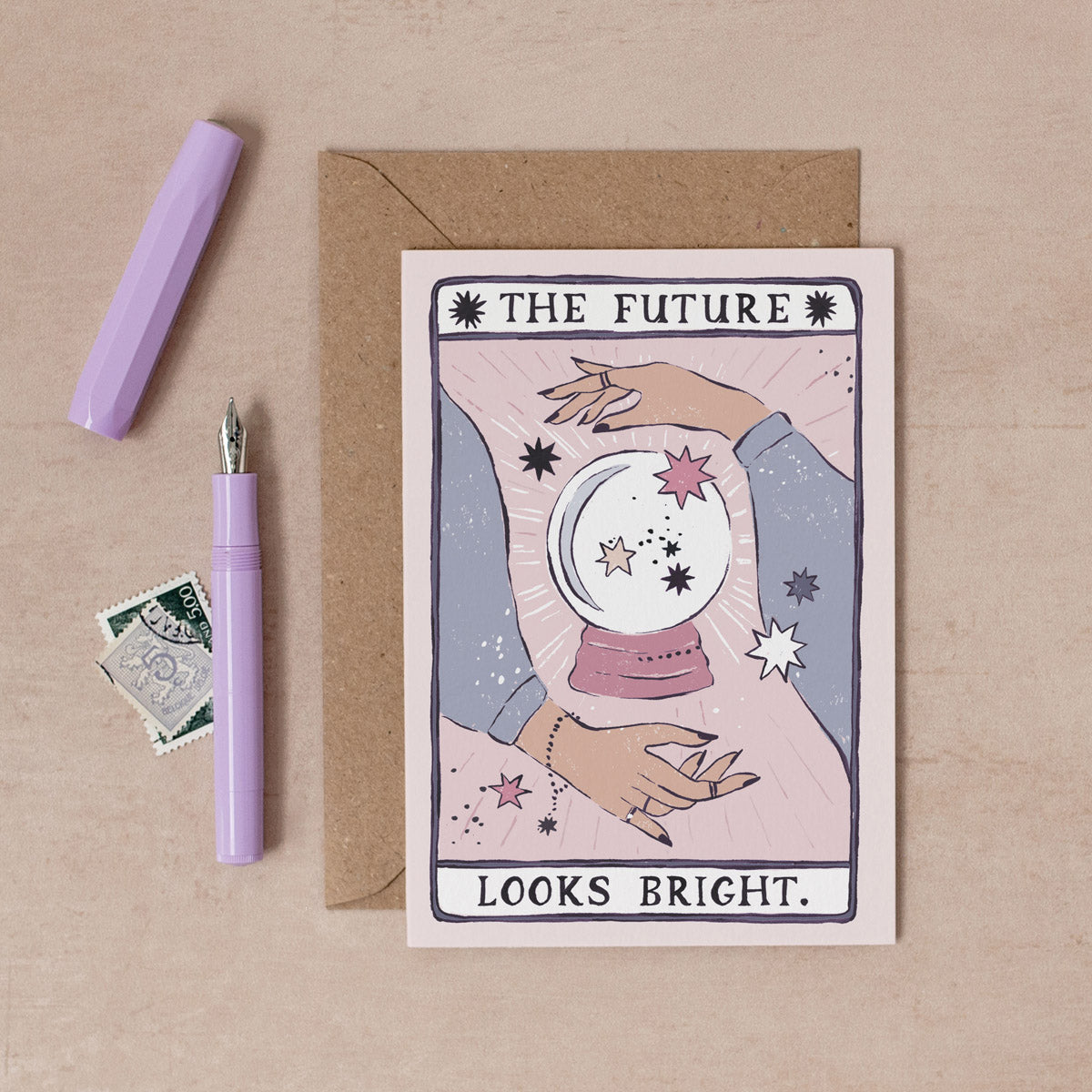 The Future Looks Bright card from the Tarot collection at Sister Paper Co features a fortune teller's hands, crystal ball and stars..