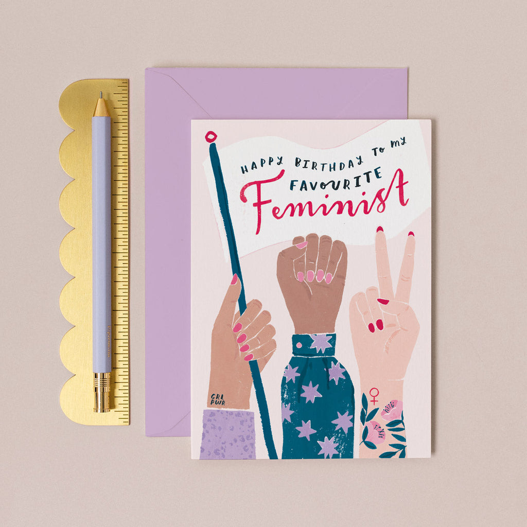 A protest flag and women's march fists illustration on a birthday card from the feminist female birthday card collection at Sister Paper Co.